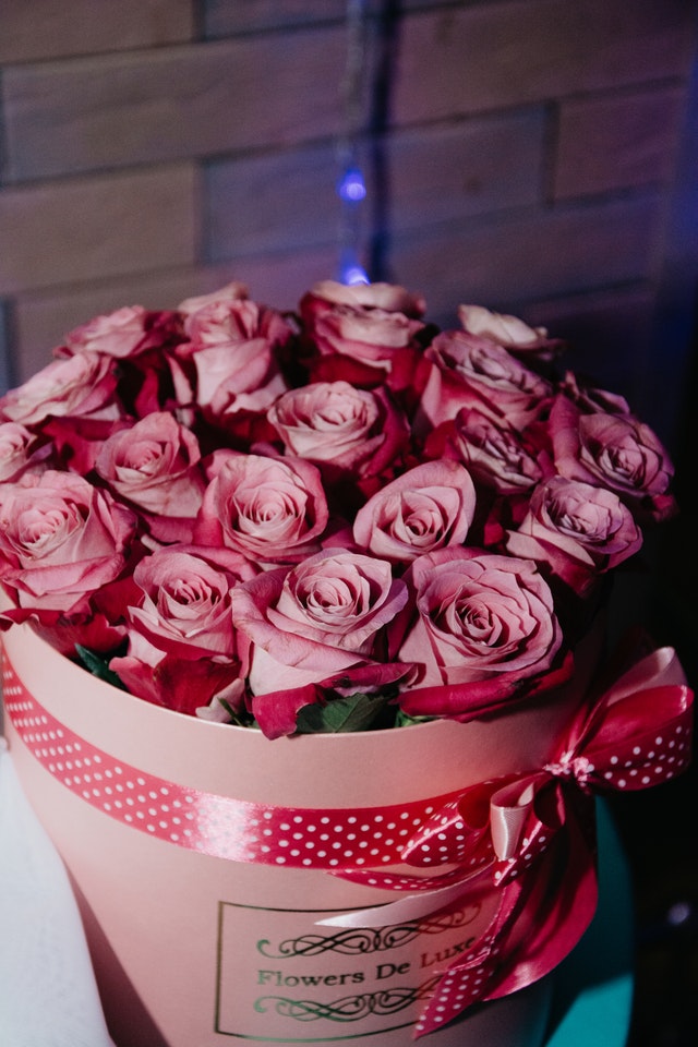 Bukiet różowych róż na tle ceglanej ścianki